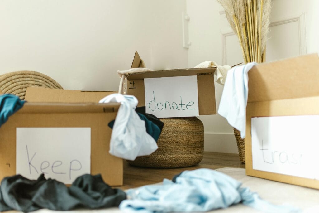 about now prim home organizer service 2 Cardboard boxes labeled keep, donate, and trash for effective home organization.